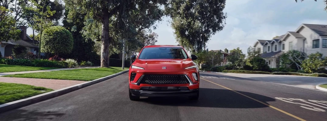A red 2026 Buick Envision drives toward the camera.